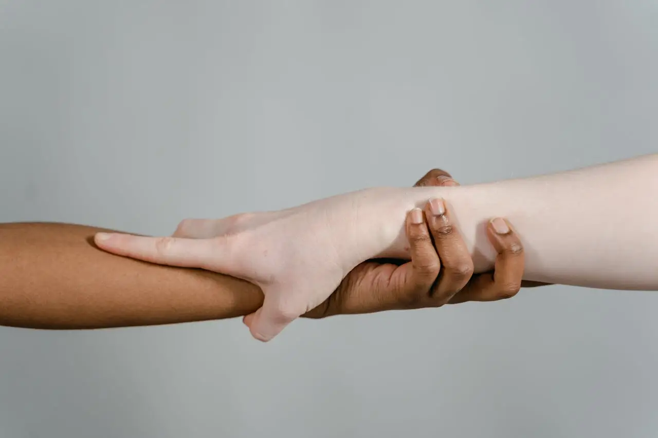 our-services-3 Close-up of hands showcasing diversity and unity through different skin tones.
